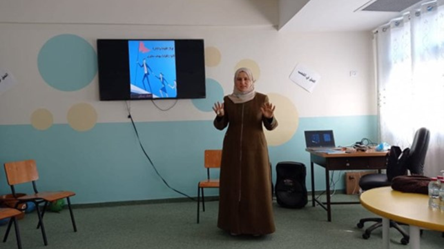 Une directrice d'école en Cisjordanie se tient debout dans une salle de classe.