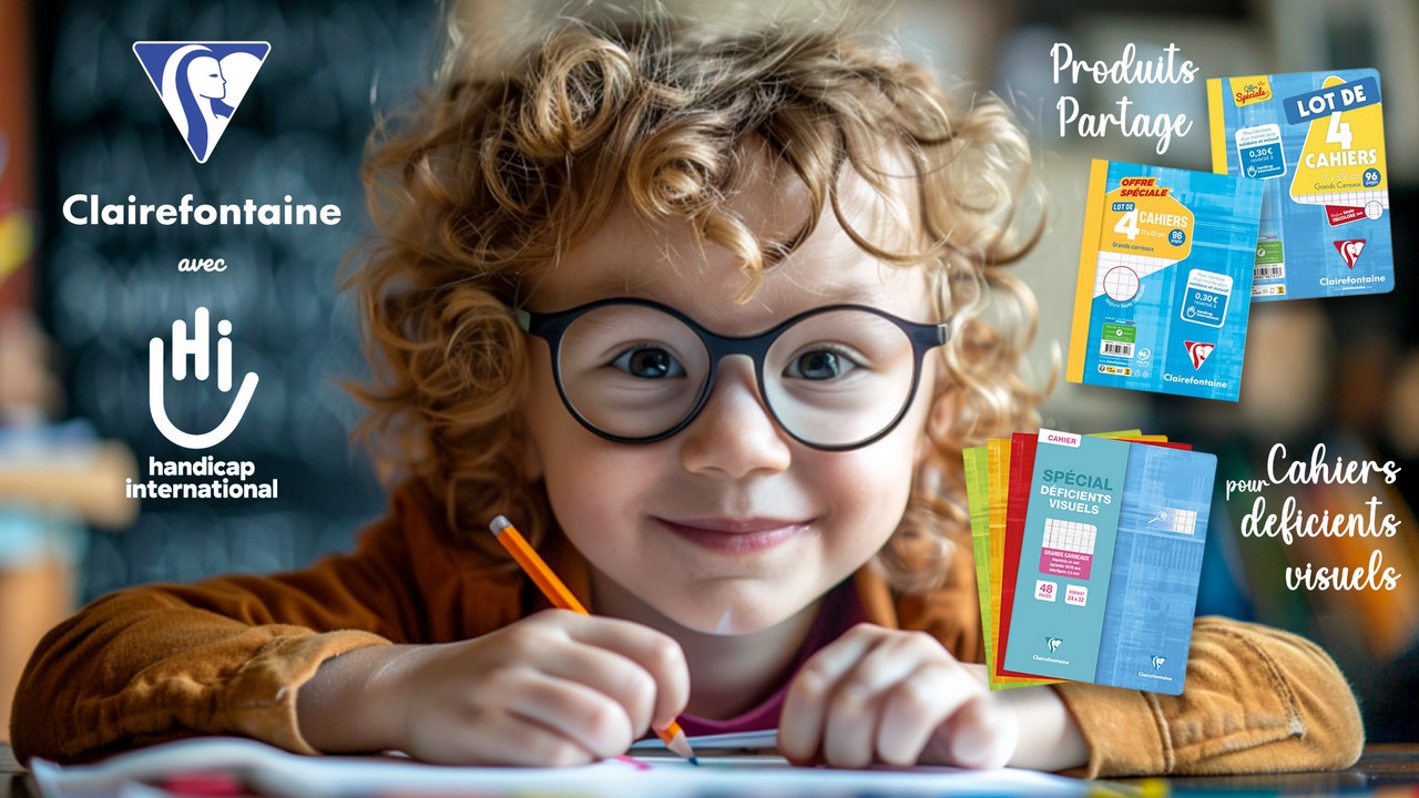 Une petite fille aux cheveux bouclés qui porte des lunettes est assise à un bureau. Elle tient dans sa main droite un crayon orange et sourit au photographe.
