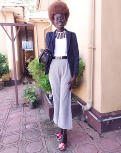 Asunta Adut se tient debout devant un immeuble à Juba, au Soudan du Sud. © B. Bringi / HI